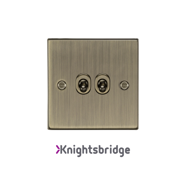 Brass-colored electrical switch with two sockets on a white background, branded 'Knightsbridge'.