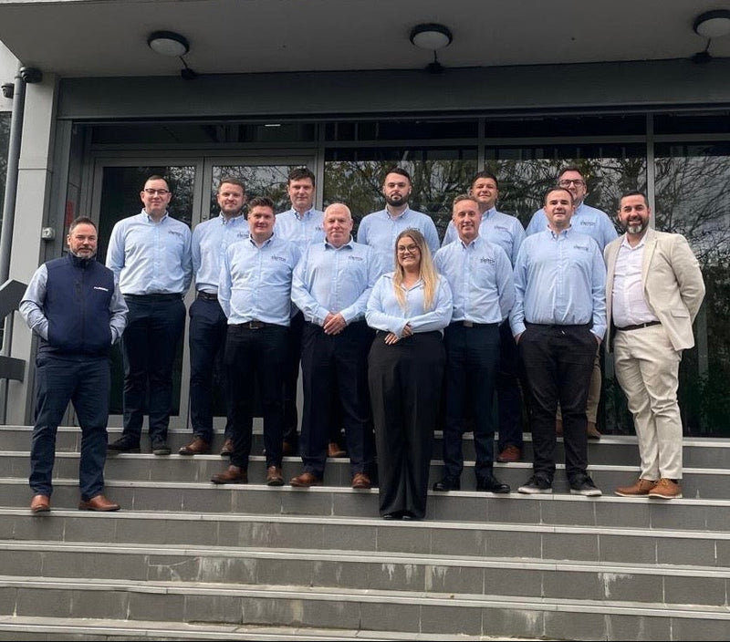 Group of people standing on steps in front of a building 
