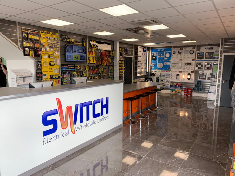 Store interior with 'SWITCH Electrical Wholesale Limited' branding on a counter.