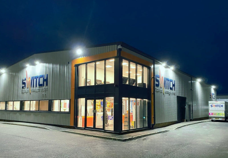 Modern building with 'Switch' branding at night